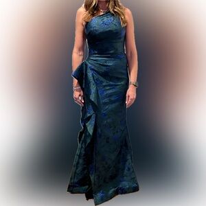 Teri Jon one-shoulder column gown showcases a cascading ruffle trim.